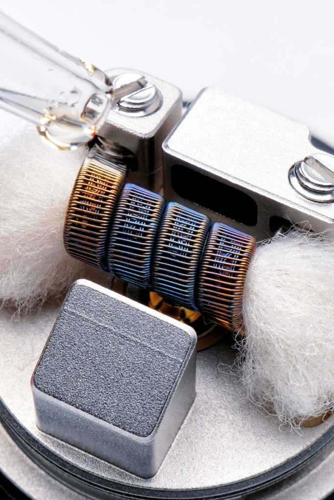 pexels-photo-3727687-3727687 Detailed macro shot of a vape coil being primed with e-liquid, showcasing technology and craftsmanship.